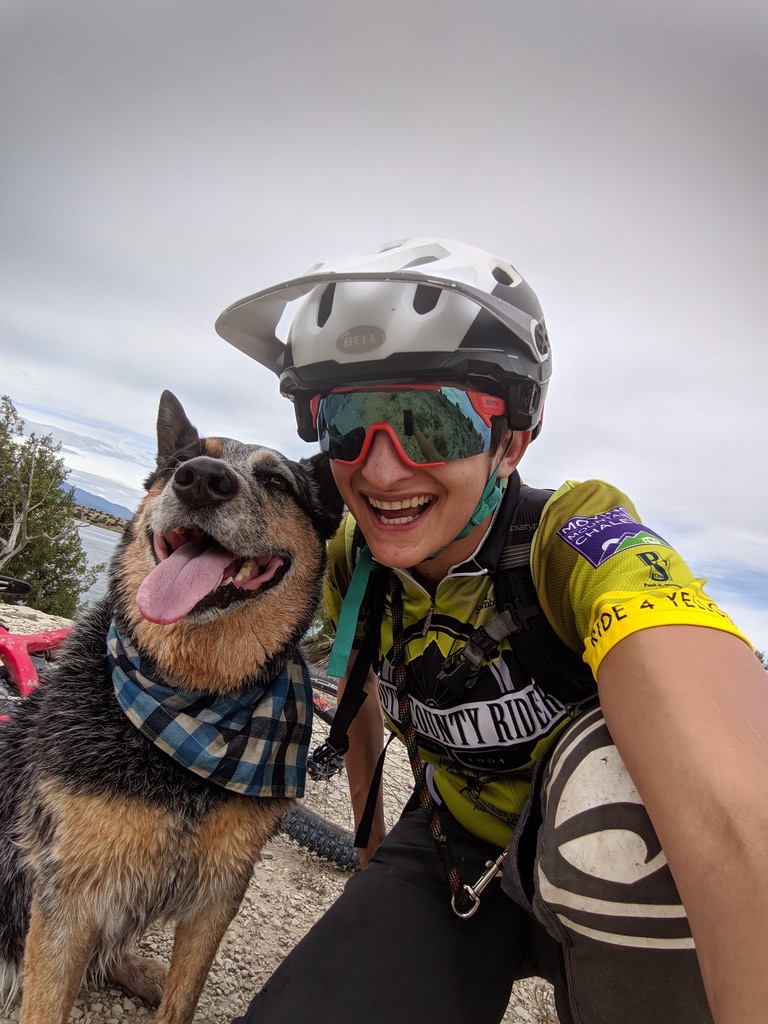 Sam and her trail dog smiling on the trail